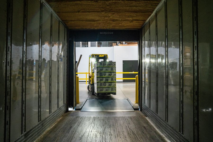 Forklift loading pallets into a trailer