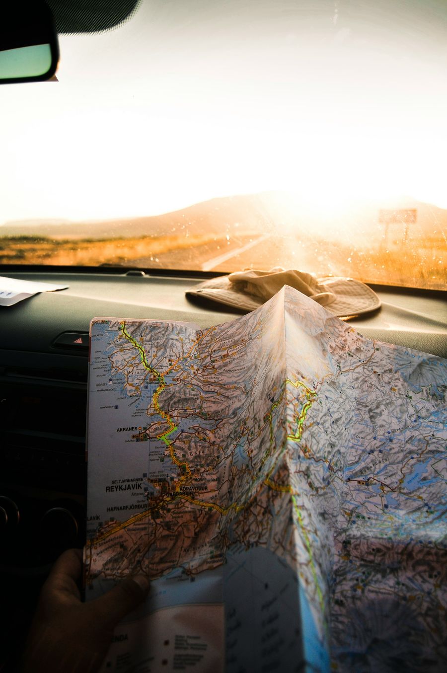 Driver planning a route with a paper map